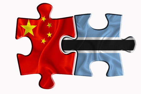 Botswana flag and China of America flag on two puzzle pieces on white isolated background. The concept of political relations. 3D renderingの写真素材