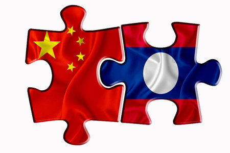 Laos flag and China of America flag on two puzzle pieces on white isolated background. The concept of political relations. 3D renderingの写真素材