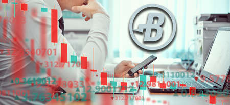 Young businessmen are analyzing the stock market at laptop. Business and finance, technology, cryptocurrency, stock crisis, falling prices, downward chart, Burst Crypto sign.の写真素材