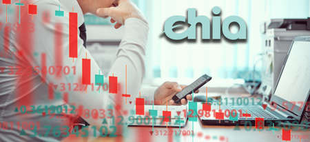 Young businessmen are analyzing stock market at laptop. Business and finance, technology, cryptocurrency, stock crisis, falling prices, downward chart, or Forex chart, Chia coin Crypto sign.の写真素材