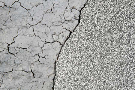 Dry mud cracked ground texture. Drought season background. Splitting in half. Concept for your design.の写真素材