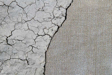 Dry mud cracked ground texture. Drought season background. Splitting in half. Concept for your design.の写真素材