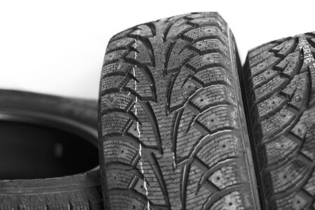 Stack of three new black tyres for winter car on white background の写真素材