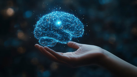 Concept illustration of a hand holding a luminous brain on a dark background. The concept of AI, science and digital technologyの素材