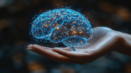 Concept illustration of a hand holding a luminous brain on a dark background. The concept of AI, science and digital technologyの素材