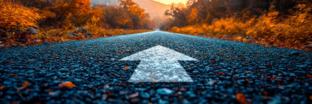 An asphalt road with an arrow painted on it symbolizes growth, development and the path to success.の素材
