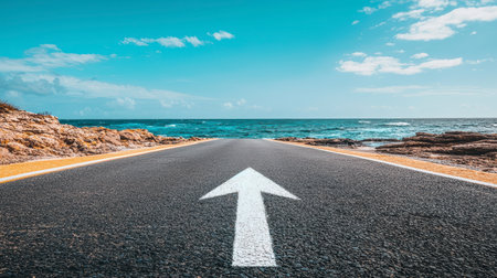 An asphalt road with an arrow painted on it symbolizes growth, development and the path to success.の素材