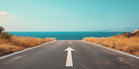 An asphalt road with an arrow painted on it symbolizes growth, development and the path to success.の素材