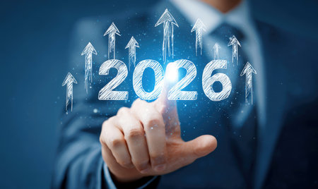 Businessman touches 2026 virtual numbers and rocket icon symbolizing business growth and innovation success.の写真素材