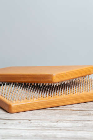 Brown Sadhu wooden boards with nails for yoga and spiritual practices on the gray background. The concept of meditation, standing on nails, therapy.の写真素材