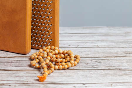 Tibetan Buddhist rosary, called mala or japamala. Brown Sadhu wooden boards with nails for yoga and spiritual practices on the gray background. The concept of meditation, standing on nails, therapy.の写真素材