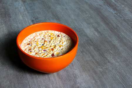 An orange bowl with milk and high protein cerealsの写真素材