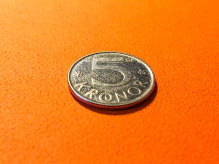 Silver coin five swedish crowns on orange backgroundの写真素材