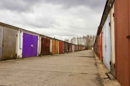 Garage community perspective on a cloudy day with purple red brown doorsの写真素材