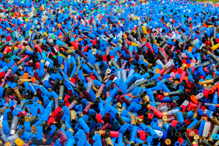 Background of many colorful empty shotgun shells, blue, red, yellow, orange, white, purple, black colored, angle view, motley patternの写真素材
