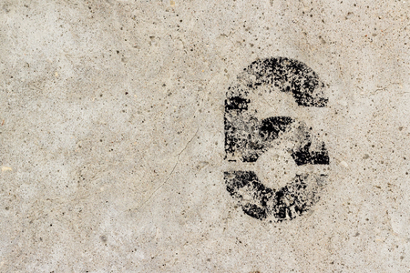 Black number six 6 ragged painted on old damaged concrete wall with copy spaceの写真素材