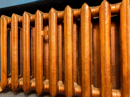 Copper heating radiator with blue wall backgroundの写真素材