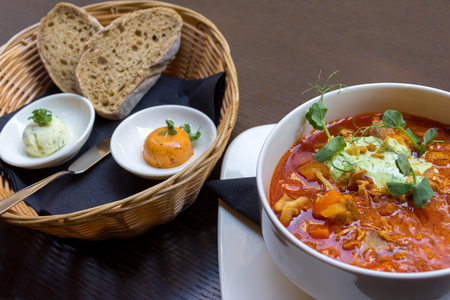 Goulash soup with lamb meat and vegetables and bread in a separate basketの写真素材