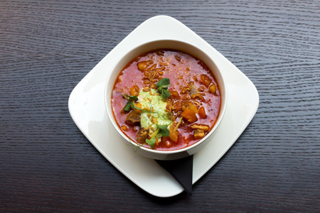 Goulash soup with lamb meat in a white plate on dark wooden table backgroundの写真素材