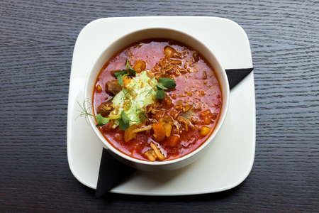 Goulash soup with lamb meat in a white plate on dark wooden table backgroundの写真素材