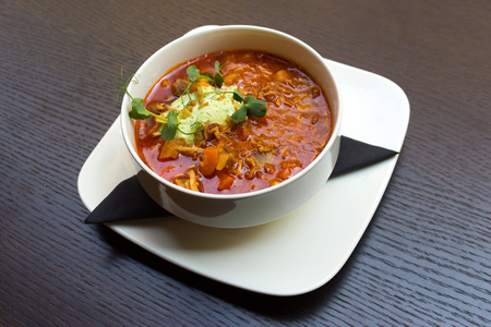 Goulash soup with lamb meat in a white plate on dark wooden table backgroundの写真素材