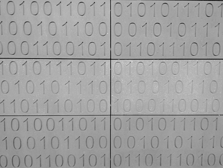 Zeroes and ones digital binary pattern on grey wall backgroundの写真素材
