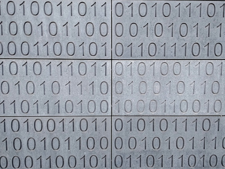 Zeroes and ones digital binary pattern on grey blue wall backgroundの写真素材