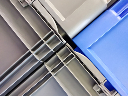 Blue and grey plastic container boxes on top of each otherの写真素材