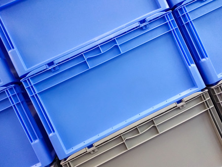 Blue and grey plastic container boxes on top of each otherの写真素材