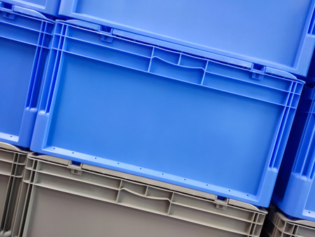 Blue and grey plastic container boxes on top of each otherの写真素材