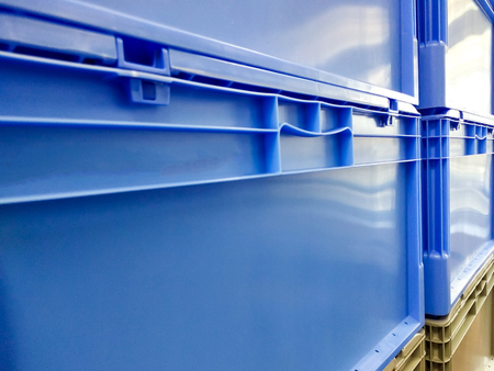 Blue and grey plastic container boxes on top of each other