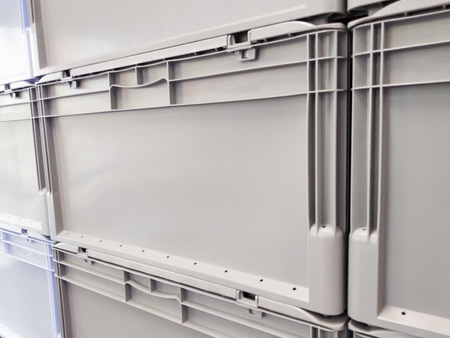 Grey plastic container boxes on top of each otherの写真素材