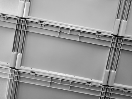 Grey plastic container boxes on top of each otherの写真素材
