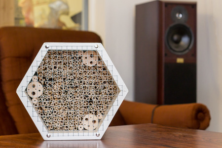 White wooden insect hotel in a light room on a tableの写真素材