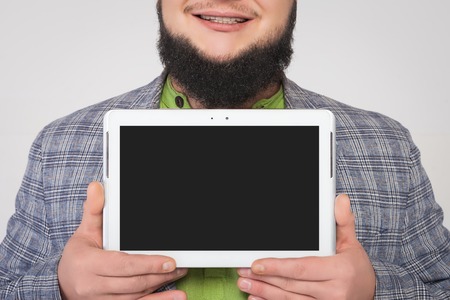 man holding a white tablet in the handsの写真素材