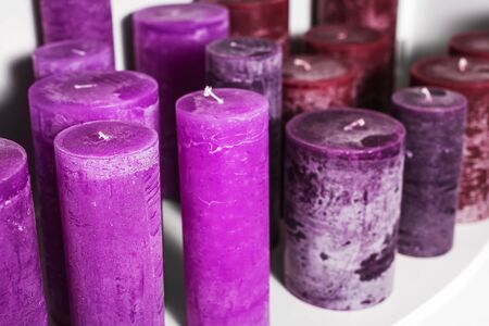 purple cylindrical candles on a shelf apartments decorの写真素材