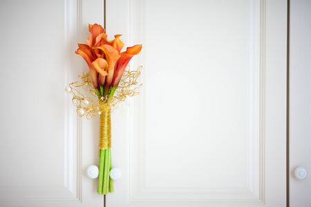 calla lilies on the background of a wooden cabinetの写真素材