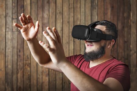 Man with virtual reality glasses showing gesture and smile