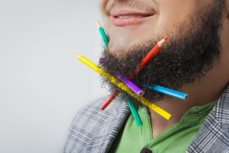 fat man with pencil in beardの写真素材