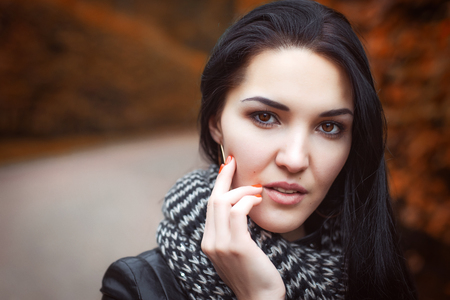 girl in black leather jacket and knitted striped scarfの写真素材