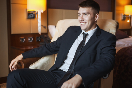 business man in suit sitting in chairの写真素材