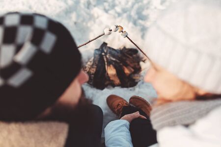Couple in love with fry marshmallows at stakeの写真素材