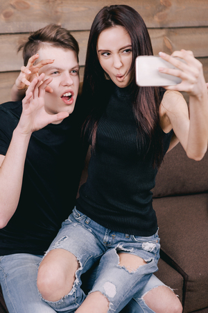 young beautiful couple taking selfie in interiorの写真素材