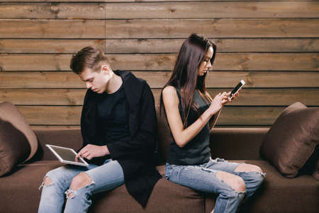 Friends with tablet and phone at homeの写真素材