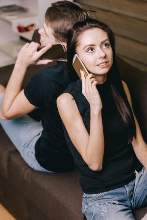 girlfriend talking on phones with her boyfriendの写真素材