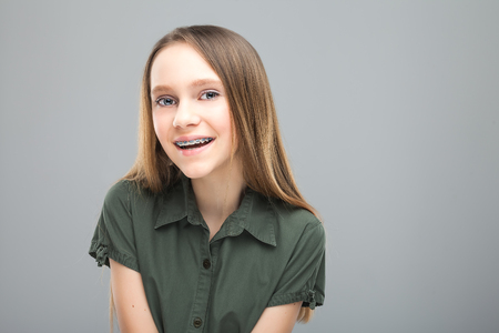 Beautiful young blonde girl with braces laughingの写真素材