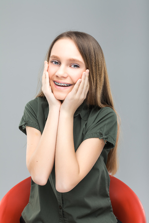 blonde girl with braces laughingの写真素材