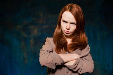 scared red-haired woman posingの写真素材