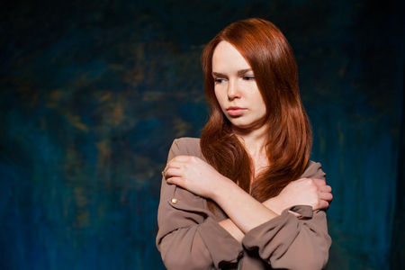 Dissatisfaction red-haired woman posingの写真素材