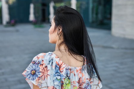 back portrait of beautiful woman in the streetの写真素材